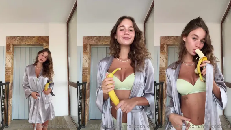 Maligoshik teasing with her tattoos and boobs while eating her banana