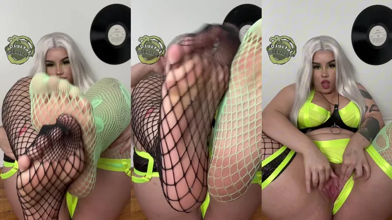 Watch the hot babe in fishnets tease and finger her pussy with her feet and lingerie on display